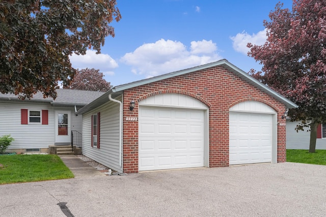 3272 Cambridge St SE, Grand Rapids, MI 49512 - ranch-style house featuring driveway, brick siding, entry steps, a garage, and a shingled roof