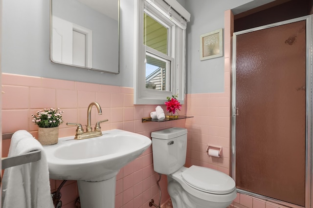 313 W Kilgore Rd, Portage, MI 49002 - full bath featuring tile walls, a shower stall, toilet, and a wainscoted wall