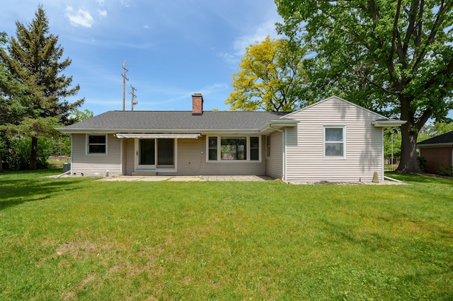 313 W Kilgore Rd, Portage, MI 49002 - rear view of property with a chimney, a patio area, and a yard