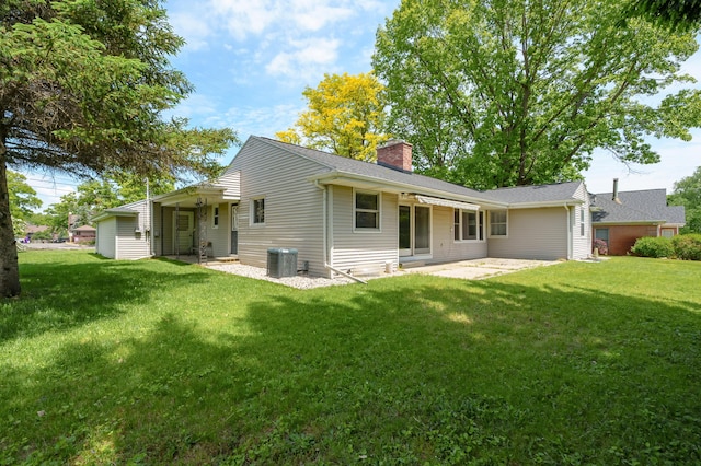 313 W Kilgore Rd, Portage, MI 49002 - rear view of house featuring a chimney, a patio, central AC, and a yard