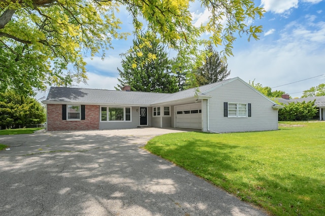 313 W Kilgore Rd, Portage, MI 49002 - single story home featuring a garage, a chimney, a front yard, driveway, and brick siding