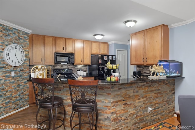340 N Wixom Rd, Wixom, MI 48393 - kitchen with black appliances, decorative backsplash, dark wood-style floors, a peninsula, and crown molding