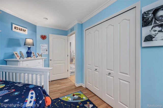 340 N Wixom Rd, Wixom, MI 48393 - bedroom with wood finished floors, crown molding, and a closet