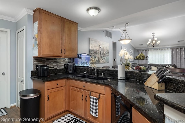 340 N Wixom Rd, Wixom, MI 48393 - kitchen with a sink, crown molding, a chandelier, vaulted ceiling, and dark stone counters