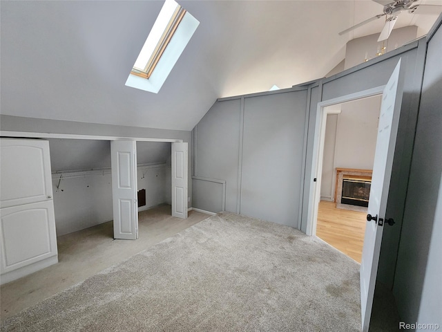 4390 Cass Elizabeth Rd, Waterford, MI 48328 - unfurnished bedroom featuring lofted ceiling, a skylight, light colored carpet, and two closets