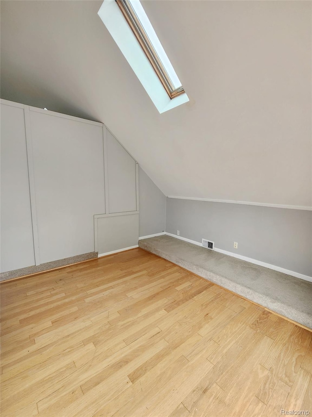 4390 Cass Elizabeth Rd, Waterford, MI 48328 - additional living space featuring a skylight, lofted ceiling, and wood finished floors