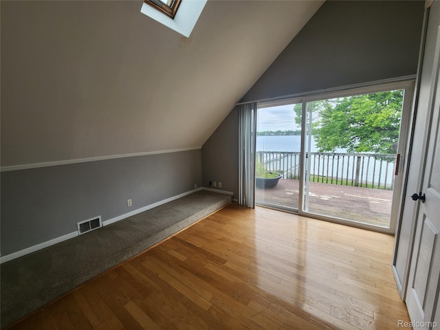 4390 Cass Elizabeth Rd, Waterford, MI 48328 - additional living space featuring vaulted ceiling, a skylight, wood finished floors, and a water view