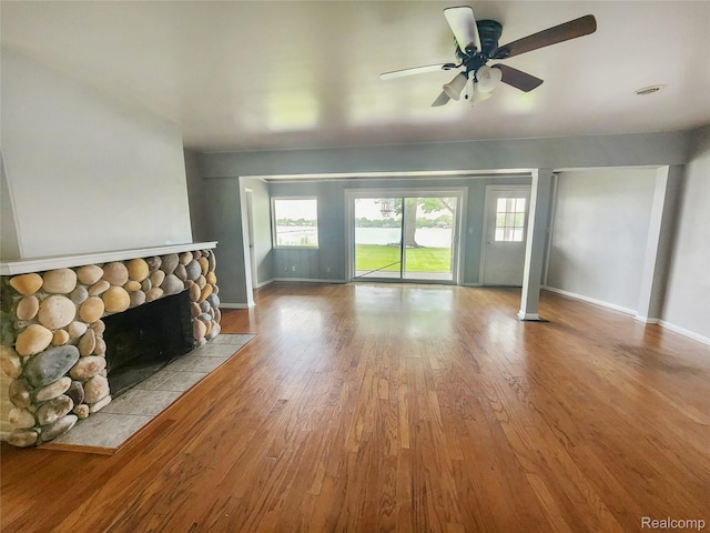 4390 Cass Elizabeth Rd, Waterford, MI 48328 - unfurnished living room featuring plenty of natural light, wood finished floors, a fireplace, and ceiling fan