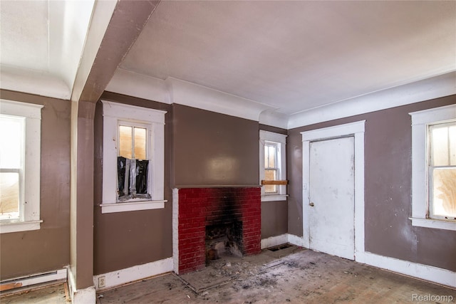 600 Alameda St, Highland Park, MI 48203 - living room with baseboard heating, a brick fireplace, and baseboards