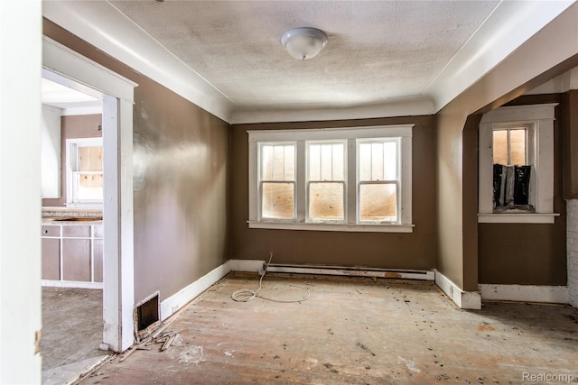 600 Alameda St, Highland Park, MI 48203 - unfurnished room with a textured ceiling, baseboards, and baseboard heating