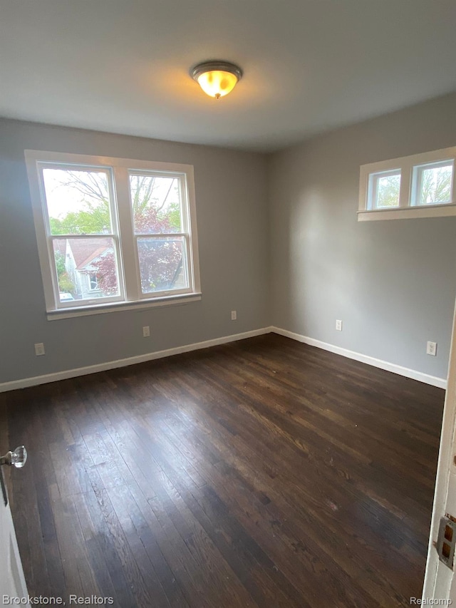 444 E Maplehurst St, Ferndale, MI 48220 - empty room with dark wood finished floors and baseboards