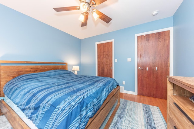 500 Little Lake Dr # 1, Ann Arbor, MI 48103 - bedroom featuring wood finished floors, baseboards, and a ceiling fan