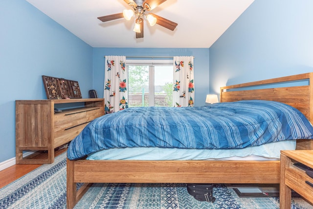 500 Little Lake Dr # 1, Ann Arbor, MI 48103 - bedroom featuring access to exterior, wood finished floors, a ceiling fan, and baseboards