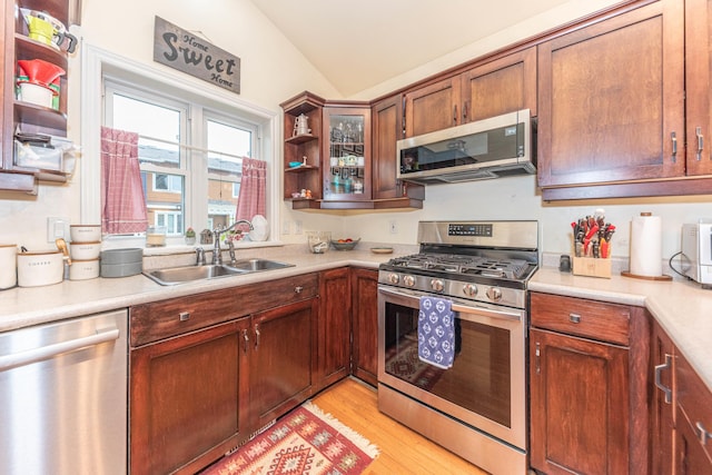 500 Little Lake Dr # 1, Ann Arbor, MI 48103 - kitchen featuring stainless steel appliances, open shelves, a sink, lofted ceiling, and light countertops