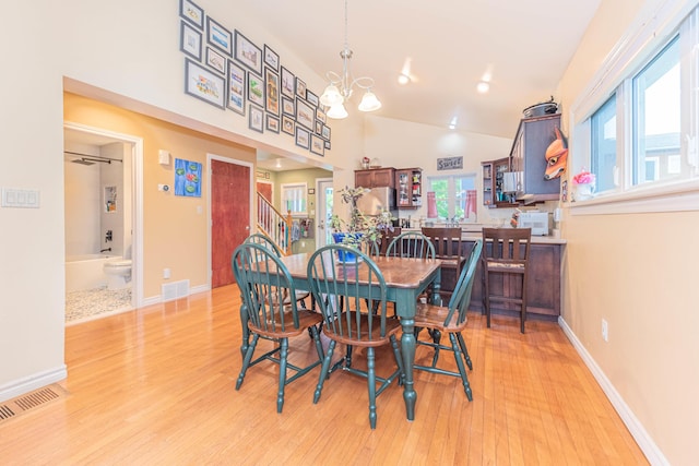 500 Little Lake Dr # 1, Ann Arbor, MI 48103 - dining area with light wood-style flooring, a chandelier, lofted ceiling, stairway, and baseboards