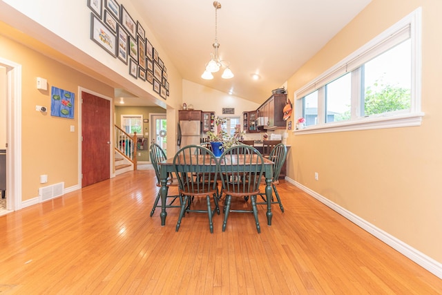 500 Little Lake Dr # 1, Ann Arbor, MI 48103 - dining space with light wood finished floors, a chandelier, stairway, baseboards, and vaulted ceiling