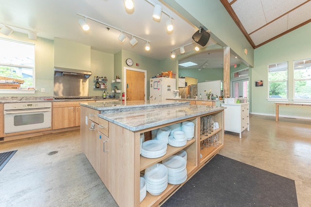 500 Little Lake Dr # 1, Ann Arbor, MI 48103 - kitchen featuring white appliances, open shelves, concrete floors, light brown cabinetry, and a center island