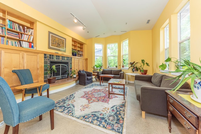 500 Little Lake Dr # 1, Ann Arbor, MI 48103 - living room with built in features, a tile fireplace, baseboards, track lighting, and vaulted ceiling