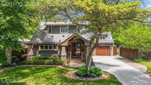 716 Magnolia Ave, Royal Oak, MI 48073 - view of front of property featuring stone siding, concrete driveway, and a garage