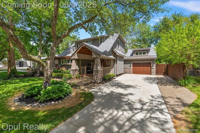 716 Magnolia Ave, Royal Oak, MI 48073 - view of front of property featuring concrete driveway, stone siding, a garage, and covered porch