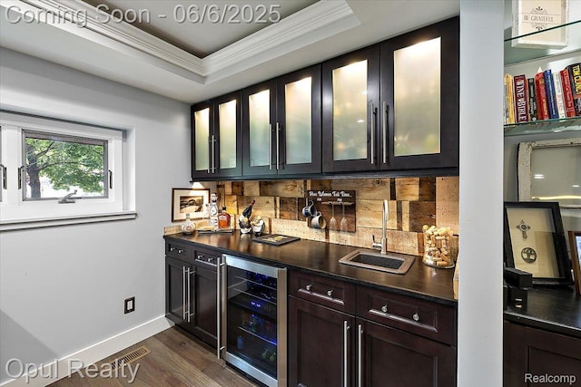 716 Magnolia Ave, Royal Oak, MI 48073 - indoor wet bar featuring beverage cooler, ornamental molding, tasteful backsplash, dark wood-style floors, and baseboards
