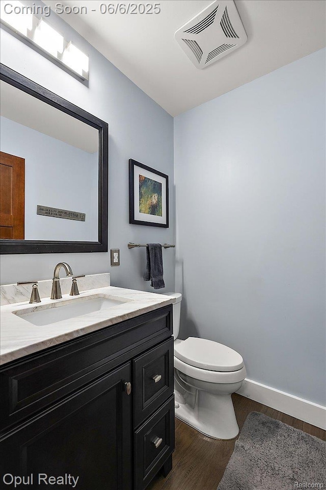 716 Magnolia Ave, Royal Oak, MI 48073 - bathroom featuring wood finished floors, vanity, toilet, and baseboards