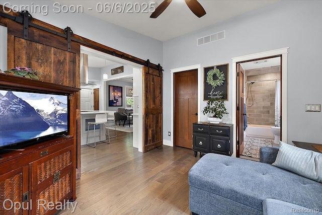716 Magnolia Ave, Royal Oak, MI 48073 - sitting room with a barn door, wood finished floors, and ceiling fan
