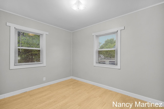 853 California St NW, Grand Rapids, MI 49504 - spare room featuring ornamental molding, wood finished floors, and baseboards