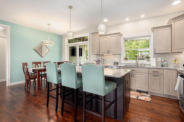 33515 28th Ave, Paw Paw, MI 49079 - kitchen with a sink, tasteful backsplash, a kitchen breakfast bar, dark wood-style flooring, and recessed lighting