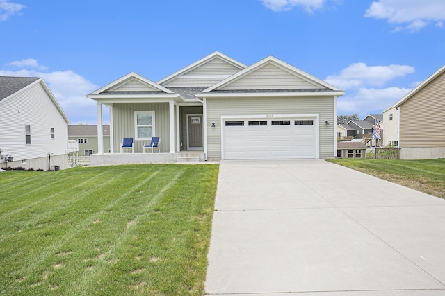 2485 Odawa Trl, Muskegon, MI 49444 - view of front of house with an attached garage, a front lawn, driveway, and board and batten siding