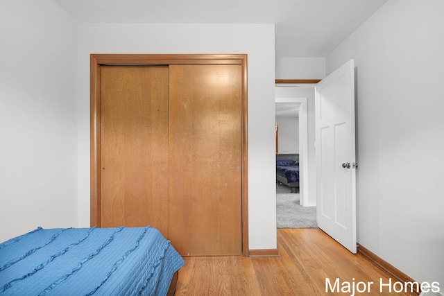 1724 Sandra St NW, Grand Rapids, MI 49544 - bedroom featuring light wood-type flooring, a closet, and baseboards