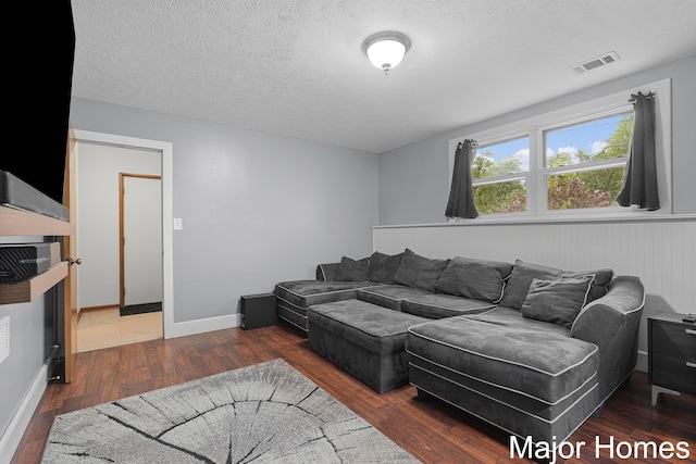1724 Sandra St NW, Grand Rapids, MI 49544 - living area featuring wood finished floors, a textured ceiling, and wainscoting