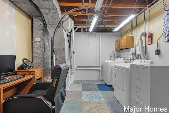 1724 Sandra St NW, Grand Rapids, MI 49544 - laundry room with washer and dryer, cabinet space, and tile patterned floors