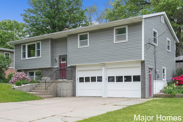 1724 Sandra St NW, Grand Rapids, MI 49544 - raised ranch with a garage and concrete driveway