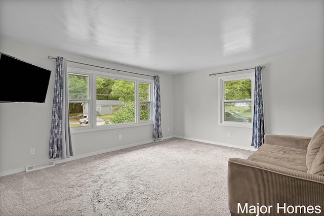 1724 Sandra St NW, Grand Rapids, MI 49544 - carpeted living room with plenty of natural light and baseboards