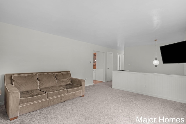 1724 Sandra St NW, Grand Rapids, MI 49544 - living area with carpet floors, a wainscoted wall, and baseboards
