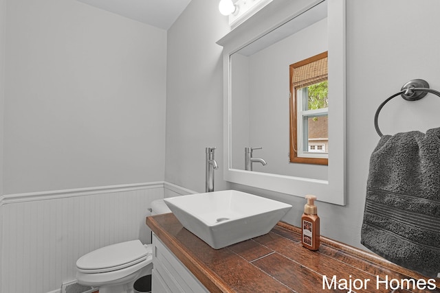 1724 Sandra St NW, Grand Rapids, MI 49544 - bathroom with a wainscoted wall, toilet, and vanity