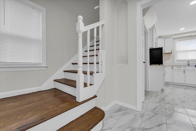 17217 Plainview Ave, Detroit, MI 48219 - staircase with baseboards, marble look tiles, and recessed lighting