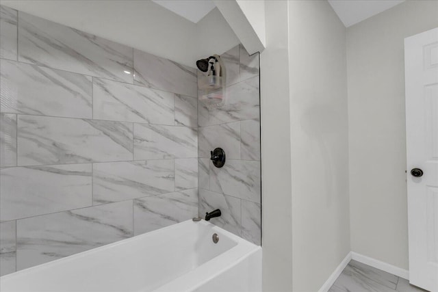 17217 Plainview Ave, Detroit, MI 48219 - bathroom featuring marble look tile flooring, baseboards, and bathing tub / shower combination