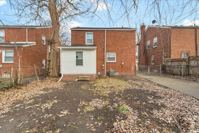 17217 Plainview Ave, Detroit, MI 48219 - back of house with central AC unit, a gate, and brick siding