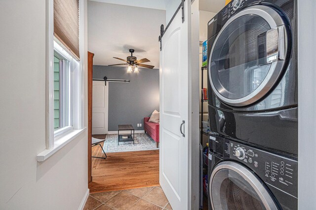 2335 Niles Ave, Saint Joseph, MI 49085 - laundry room featuring a barn door, stacked washer / drying machine, baseboards, and ceiling fan