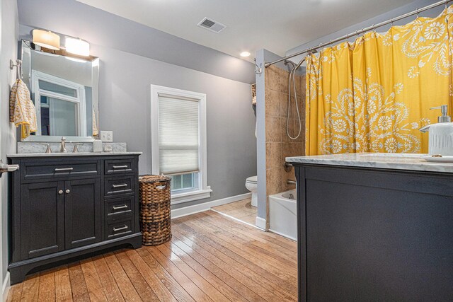2335 Niles Ave, Saint Joseph, MI 49085 - bathroom with vanity, shower / bath combo, baseboards, toilet, and wood-type flooring