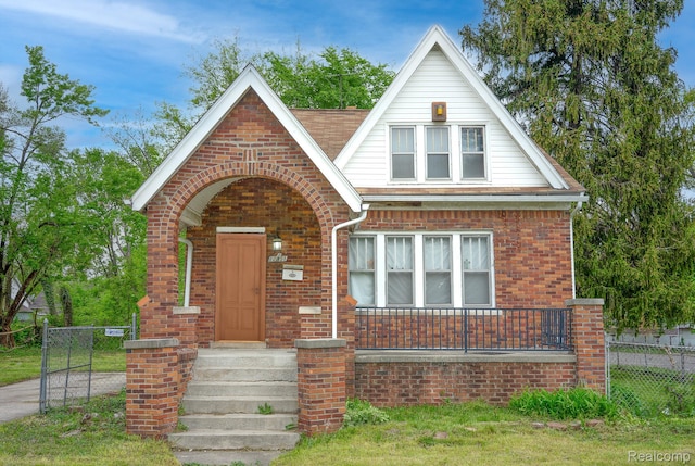 12151 Corbett St, Detroit, MI 48213 - tudor house with brick siding and a gate