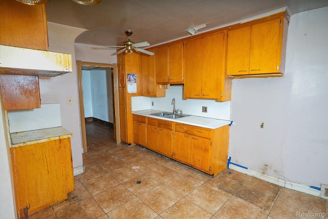 12151 Corbett St, Detroit, MI 48213 - kitchen featuring a sink, light countertops, a ceiling fan, brown cabinets, and light tile patterned floors