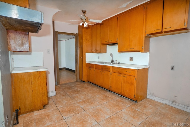12151 Corbett St, Detroit, MI 48213 - kitchen featuring ceiling fan, light countertops, brown cabinets, and light tile patterned flooring