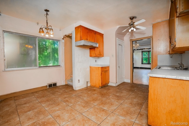 12151 Corbett St, Detroit, MI 48213 - kitchen with a chandelier, light countertops, a ceiling fan, and light tile patterned floors