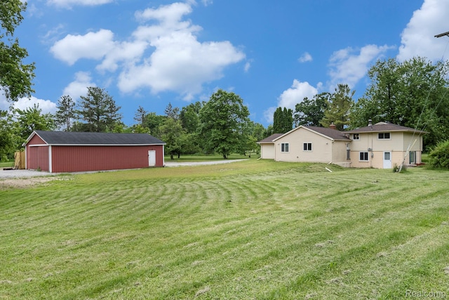 7340 Hartland Rd, Fenton, MI 48430 - view of grassy yard featuring an outbuilding and an outdoor structure