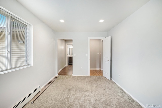 7340 Hartland Rd, Fenton, MI 48430 - unfurnished bedroom featuring a baseboard radiator, light carpet, recessed lighting, and baseboards