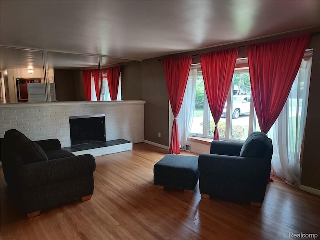 24781 Larkins St, Southfield, MI 48033 - living room featuring wood finished floors, baseboards, and a fireplace