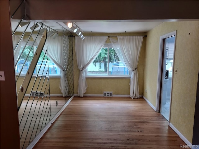 24781 Larkins St, Southfield, MI 48033 - unfurnished room featuring healthy amount of natural light, wood finished floors, and baseboards